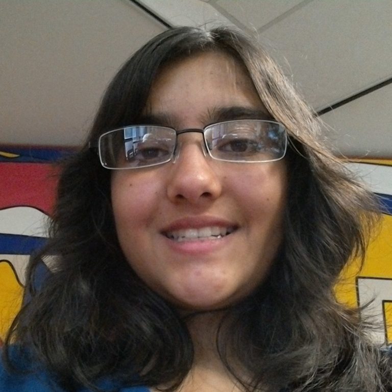 A person with long dark hair and glasses smiles at the camera; colorful background with yellow and blue elements behind them.