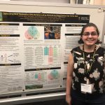 A young woman stands and smiles in front of a scientific research poster about DNA metabarcoding methods for studying sea turtle diets at an academic conference.